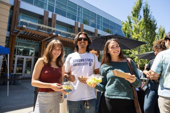 Three students pose with their food