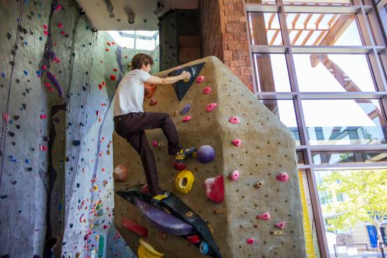 Student climbs rec center rock wall