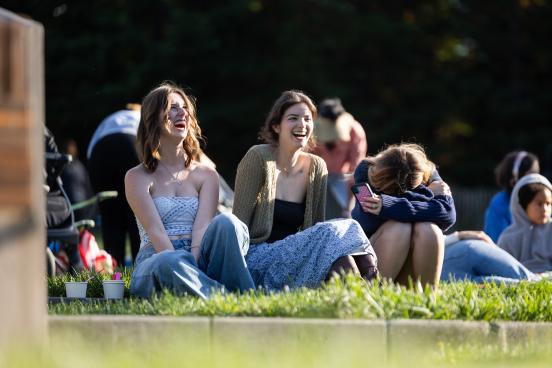 Group of friends laughing on the lawn