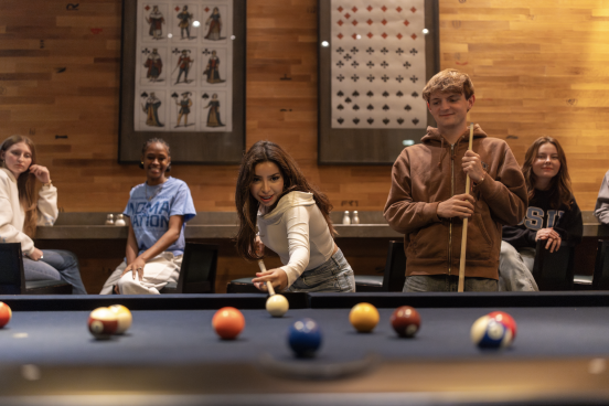 Students play pool together