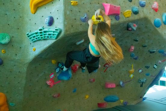 Student climbs rec center rock wall