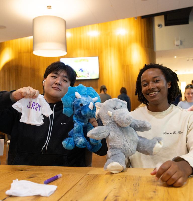 Two students hold up their build-a-bears