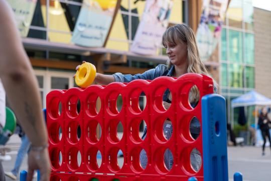 A student plays giant connect four game