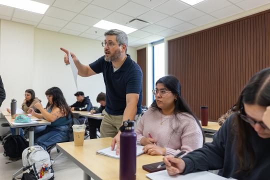 Teacher helps answer student's question
