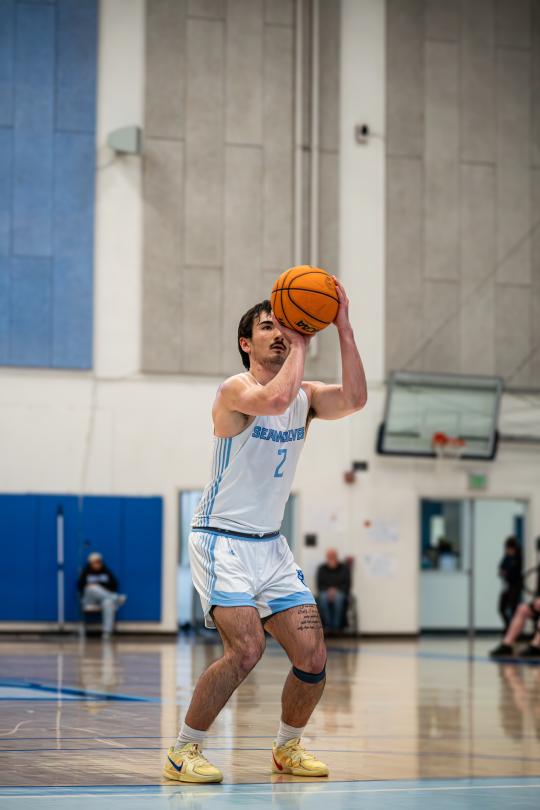 Basketball player shoots the ball