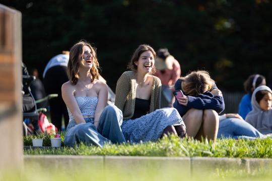 Group of friends laughing on the lawn