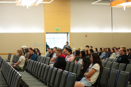 An audience watches intently