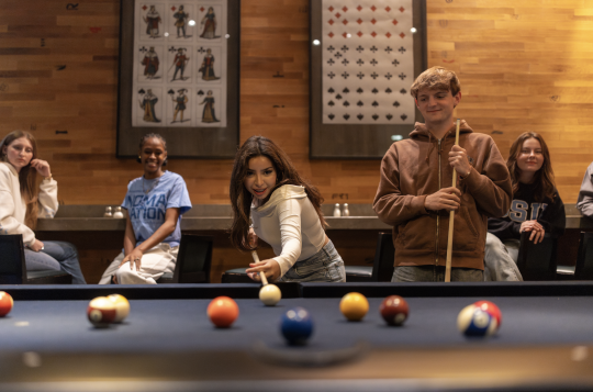 Students play pool together