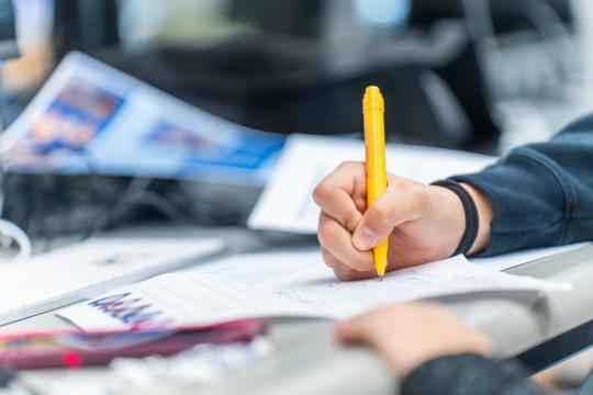 Close up of someone writing notes