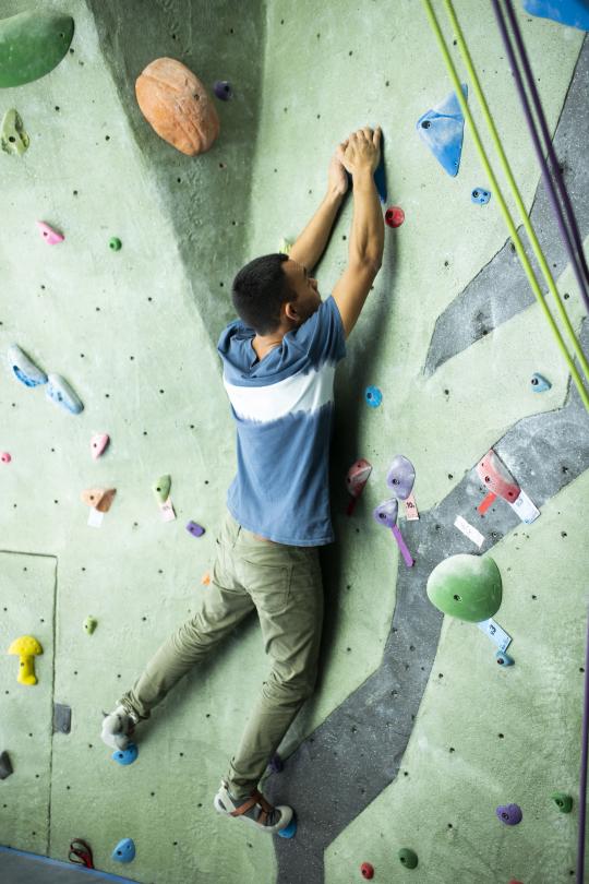 Student climbs rec center rock wall