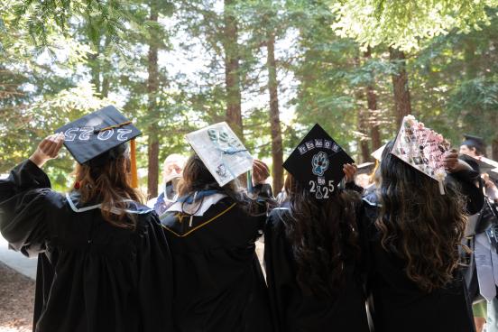 Four ssu students showing their graduation caps
