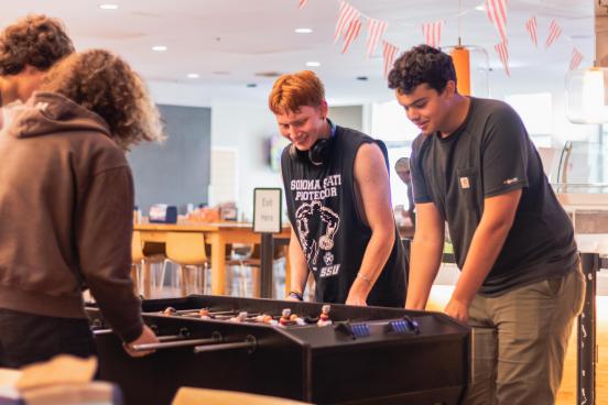 Siblings playing foosball