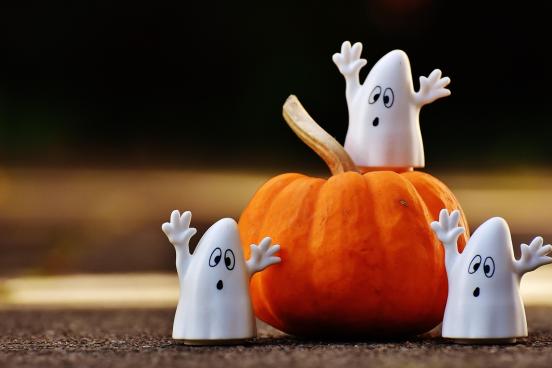 ghost decorations around a pumpkin