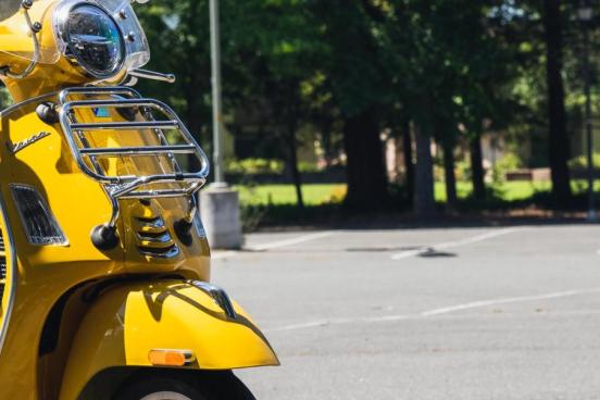Yellow scooter in a parking lot
