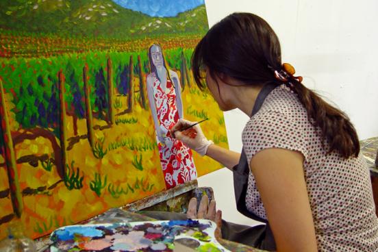 Student painting a portrait of a woman at a Sonoma winer