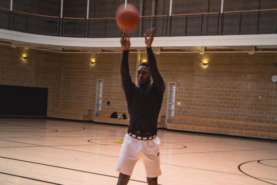 Students shooting a basketball