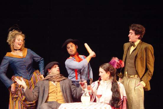 Group of people in costume performing Les Miserables 