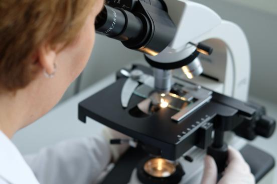 Woman looking into microscope