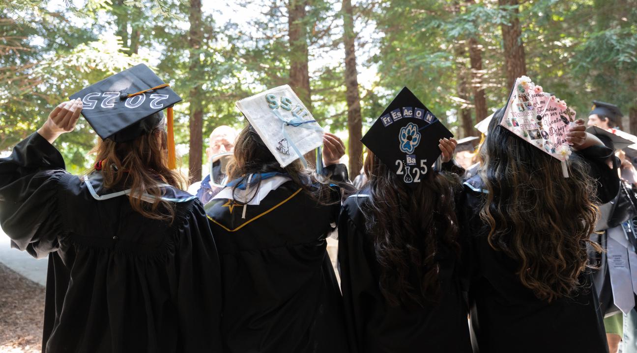 Four ssu students showing their graduation caps