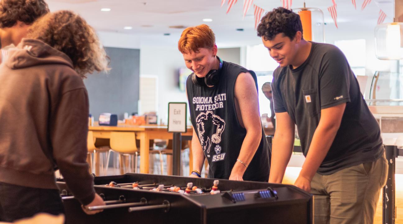 Siblings playing foosball