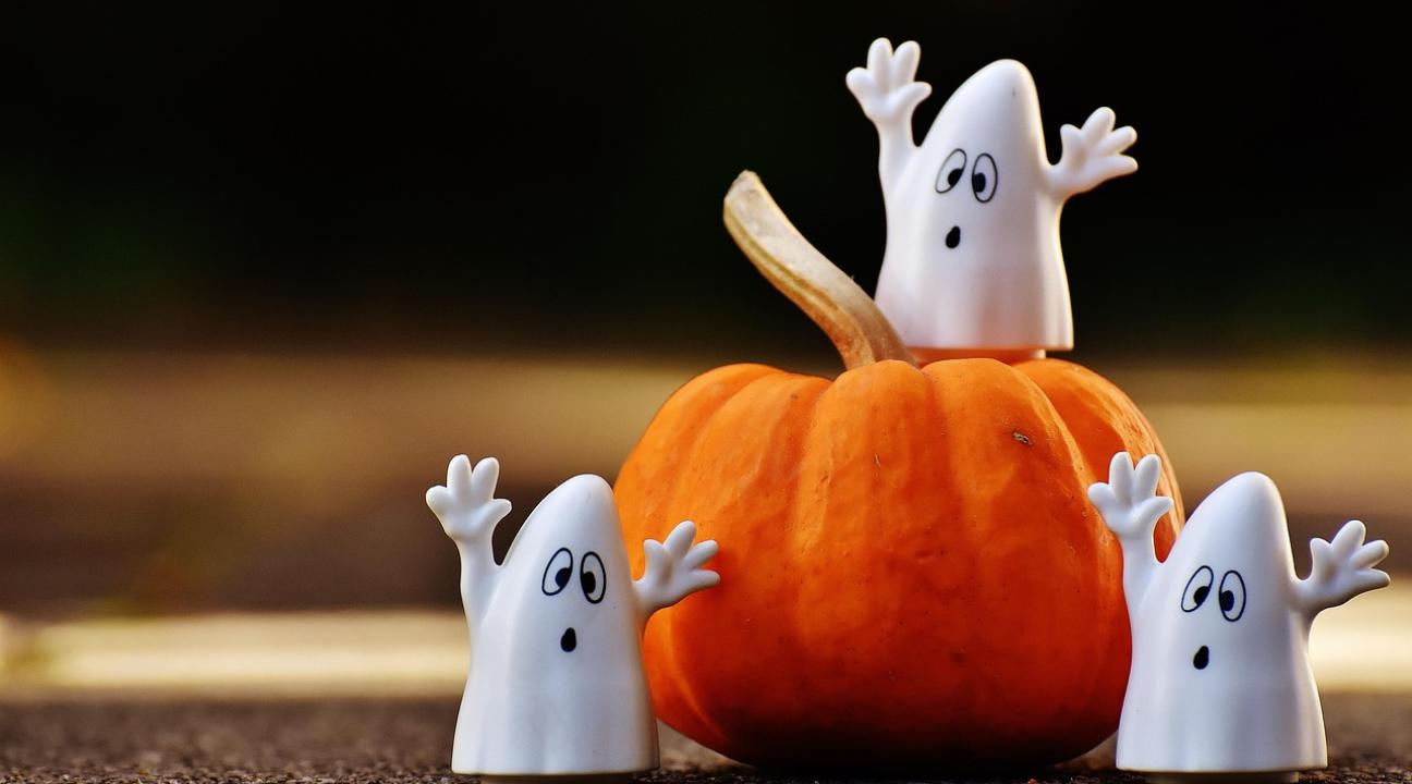ghost decorations around a pumpkin