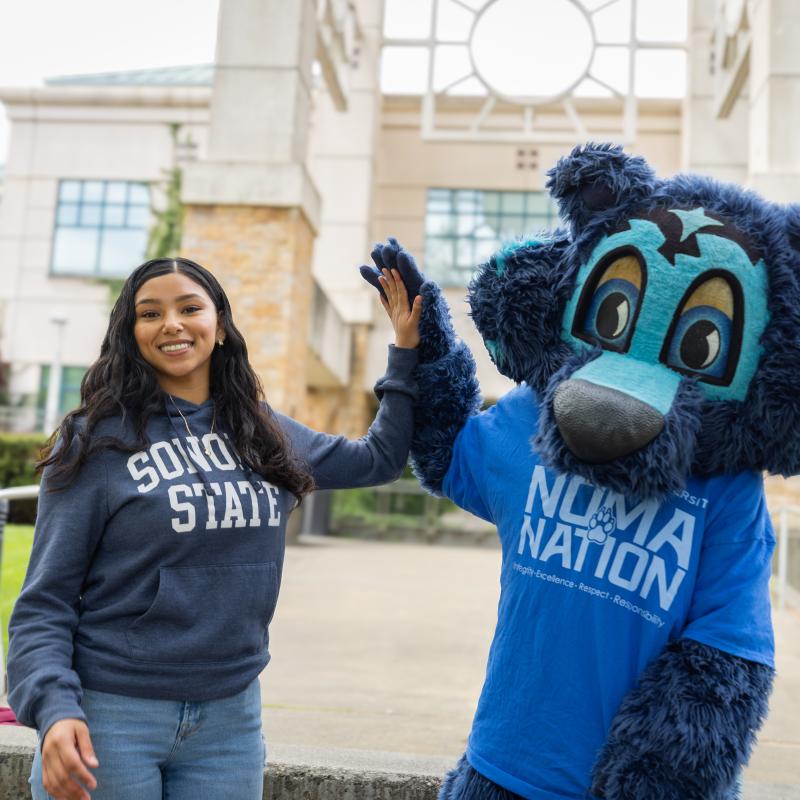 Student high fiving Lobo