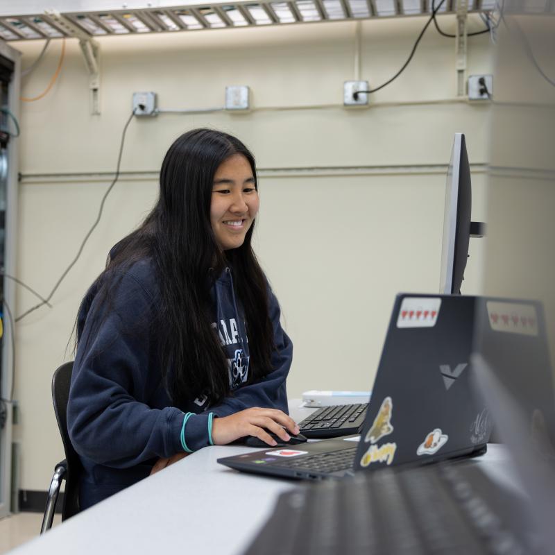Student in a classroom on a computer