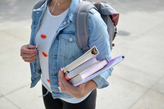Student carrying books for morning class