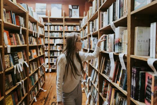 Student looking for a book at the library