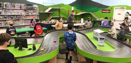 Student's sibling playing with remote control cars