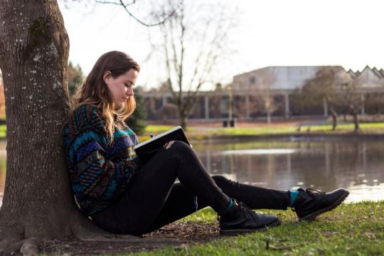 student reading by ssu lake