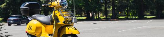 Yellow scooter in a parking lot