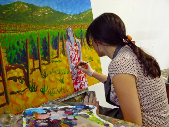 Student painting a portrait of a woman at a Sonoma winer