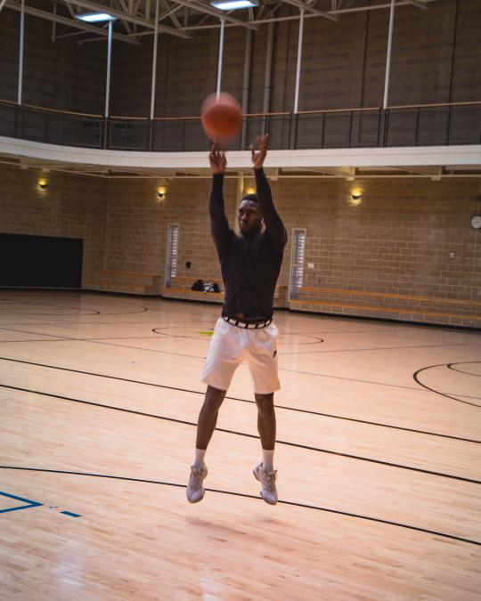 Students shooting a basketball