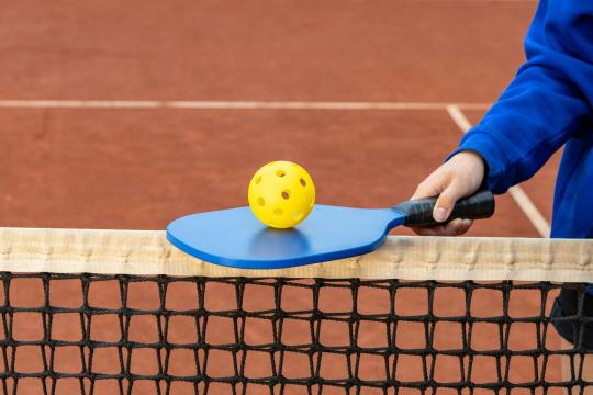 Athlete holding a pickeball paddle