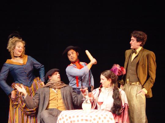 Group of people in costume performing Les Miserables 