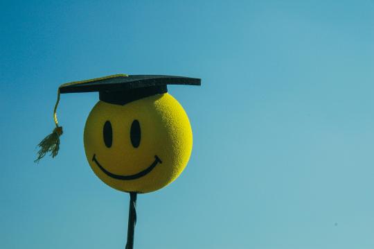 smily face wearing grad cap