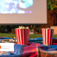 Two Popcorn Buckets with Outdoor movie setup